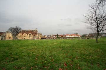 View of St. Augustine's Abbey from just outside the Visitor's Centre. Straight head is the north wall of the Norman nave; the wooden roof covers part of the Anglo-Saxon church; the ruins to the right are from the east end of the abbey church.