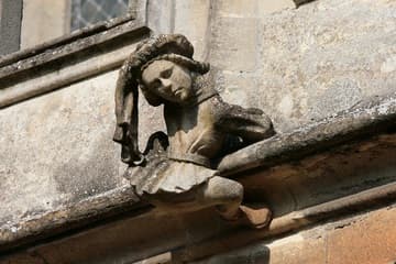A boy climbs up the church on the south exterior over the third window.