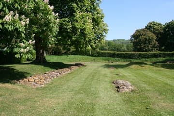 A grassy patch where the great abbey church used to be, looking east to the altar and ambulatory from the north transept.