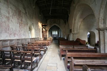 Early English nave looking east, with medieval murals on the left.