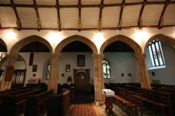 The 15th-century arcade and wagon roof with angel statues.
