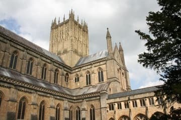 View of the central tower (14C) and nave (13C) from the cloister (15C). Wells Cathedral, Wells, Somerset, England.