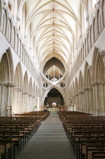 Looking east in the Gothic nave (early 13th century), with the famous scissor arches added in 1338. Wells Cathedral, Wells, Somerset, England.