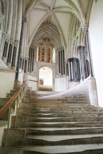 The well-worn medieval stairs to the Chapter House (right) and Vicars' Close (straight ahead). Wells Cathedral, England.