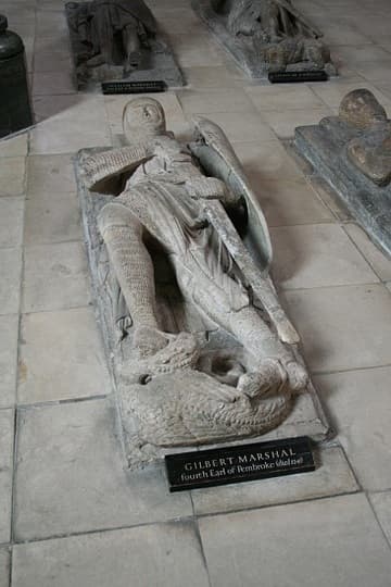 Gilbert Marshal Earl of Pembroke (d.1241). One of ten knightly memorials in the round nave of the Temple Church, London. These were believed to be tombs until the post-WWII restoration revealed no bodies, but only effigy memorials. All the knights are on their back, but are otherwise positioned in different ways: some have their legs extended straight out while others have their legs crossed; some wear tunics over their armor and others wear full-length robes; some clutch their swords, some pray, and some have their arms straight at their sides. One has no effigy at all, but only a trapezoidal sarcophagus lid.