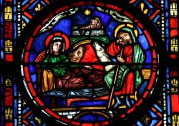 Medieval stained glass panel depicting the Nativity of Christ.