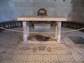 Mosaic of loaves and fishes with the sacred stone under the altar.