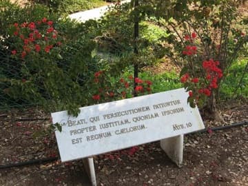 In the gardens, a marble plaque bears one of the Beatitudes in Latin.