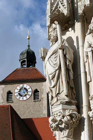 Detail of west portal statues, with clock tower in the background.
