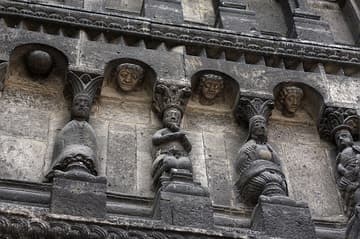 Carytids on the left middle tier, possibly depicting virtues.