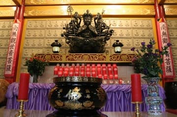 Kwan Yin shrine with incense pot in the main temple hall.