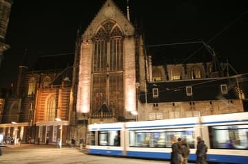 The Nieuwe Kerk by night, with swiftly passing tram.