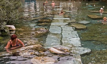 Swimming with artifacts in the sacred thermal pool.