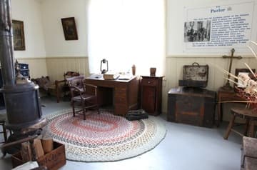 Parlor room of the Parish House, rebuilt in 1887 after a fire destroyed the original. The Sacred Heart Mission near Coeur d'Alene was built 1850-53 by Jesuit missionaries and Native Americans. It is the oldest building in Idaho. Today it is owned by the Coeur d'Alene tribe and operated by the state as Old Mission State Park.