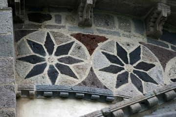 Detail of inlaid stone mosaic on the apse, 12th century. Saint-Nectaire Church, Auvergne, France.