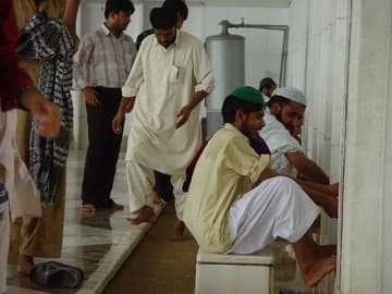 Performing ablutions before prayer at Faisal Mosque.