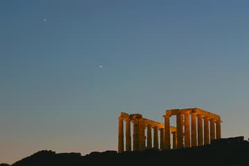 Temple of Poseidon at sunset, with Jupiter and Venus in the western sky.