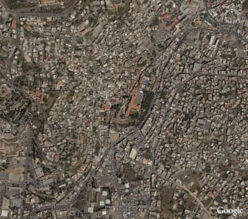 Satellite image of the Basilica of the Annunciation (dark blue dome below the red roofs in the center). Image courtesy of Google Earth. For a large and fully interactive version of this view, see our Nazareth Satellite Map. Related pages:
