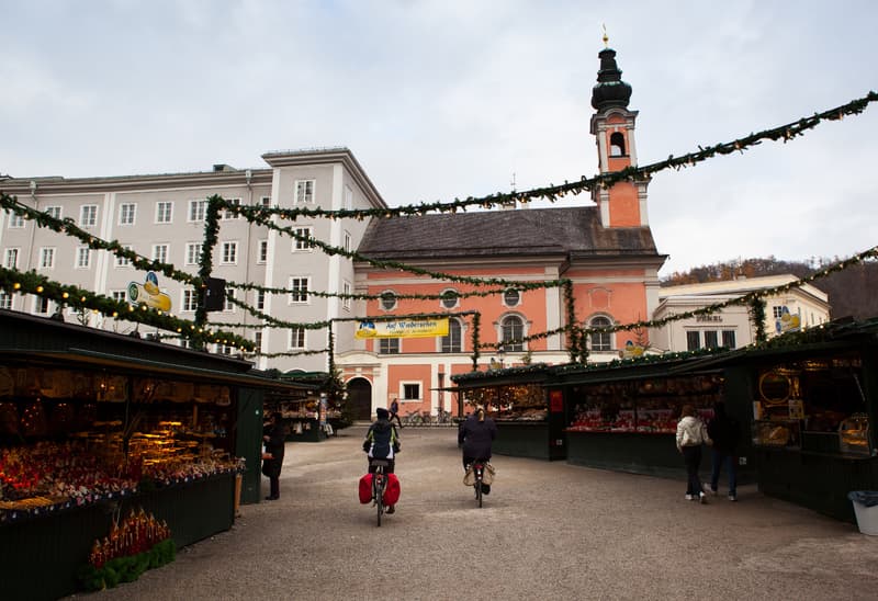 View of St. Michael's Church from south, with the Christmas Market in the foreground. Salzburg, Austria.