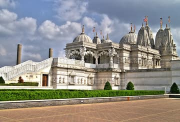 The Mandir is the focal point of the complex. Designed according to the Stapatya-Shastra, a Vedic text that develops Hindu architecture to metaphorically represent the different attributes of God, it is constructed almost entirely from Indian marble, Italian marble and Bulgarian limestone. The stone was shipped to India where it was hand-carved by over 1,500 craftsmen. Each individually numbered piece was then shipped back to London and the building was assembled like a giant three-dimensional jigsaw. The Mandir facility contains no iron or steel, a unique feature for a modern building in the UK. A feature the temple is noted for is its profusely carved cantilevered dome, believed to be the only one in Britain that does not use steel or lead. The Mandir was inaugurated on 20 August 1995 by Pramukh Swami Maharaj, the spiritual leader of BAPS - the organisation behind the temple.

The Mandir serves as the centre of worship. Directly beneath each of the seven pinnacles seen from the outside is a shrine. Each of these seven shrines houses murtis (images) within golden altars. Each murti is treated like the incarnation of Godhead and therefore each deity is bathed, clothed, fed, and attended to each day by the sadhus (monks) who live in the temple.

Beneath the Mandir, is the permanent exhibition 'Understanding Hinduism'. Spread over 3000 square feet, the exhibition deals with the origin, beliefs, glory and contribution of Hindu seers and scholars in the fields of mathematics, astronomy, medicine, education, and religion. The messages and information are presented through visual effects, paintings, tableaux, traditional craftwork, and miniature 3-D dioramas.