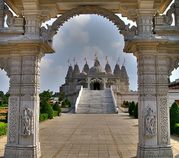 The Mandir is the focal point of the complex. Designed according to the Stapatya-Shastra, a Vedic text that develops Hindu architecture to metaphorically represent the different attributes of God, it is constructed almost entirely from Indian marble, Italian marble and Bulgarian limestone. The stone was shipped to India where it was hand-carved by over 1,500 craftsmen. Each individually numbered piece was then shipped back to London and the building was assembled like a giant three-dimensional jigsaw. The Mandir facility contains no iron or steel, a unique feature for a modern building in the UK. A feature the temple is noted for is its profusely carved cantilevered dome, believed to be the only one in Britain that does not use steel or lead. The Mandir was inaugurated on 20 August 1995 by Pramukh Swami Maharaj, the spiritual leader of BAPS - the organisation behind the temple.

The Mandir serves as the centre of worship. Directly beneath each of the seven pinnacles seen from the outside is a shrine. Each of these seven shrines houses murtis (images) within golden altars. Each murti is treated like the incarnation of Godhead and therefore each deity is bathed, clothed, fed, and attended to each day by the sadhus (monks) who live in the temple.

Beneath the Mandir, is the permanent exhibition 'Understanding Hinduism'. Spread over 3000 square feet, the exhibition deals with the origin, beliefs, glory and contribution of Hindu seers and scholars in the fields of mathematics, astronomy, medicine, education, and religion. The messages and information are presented through visual effects, paintings, tableaux, traditional craftwork, and miniature 3-D dioramas.