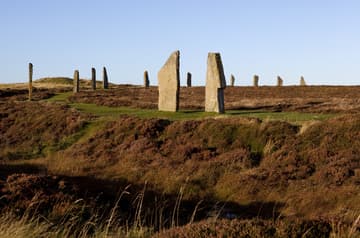 View from southeast, with stone 12 (left) and stone 11 (right) prominent in the foreground. Ring of Brodgar, c. 2500 BC, Mainland, Orkney Islands, Scotland. Measuring nearly 104 m in diameter, this impressive Neolithic monument is a true circle that is thought to have originally consisted of 60 stones. Today 27 stones remain standing, ranging in height from 2.1 m to 4.7 m. The ring is positioned on a scenic strip of land between the freshwater Loch of Harray (to NE) and the saltwater Loch of Stenness (to SW).
