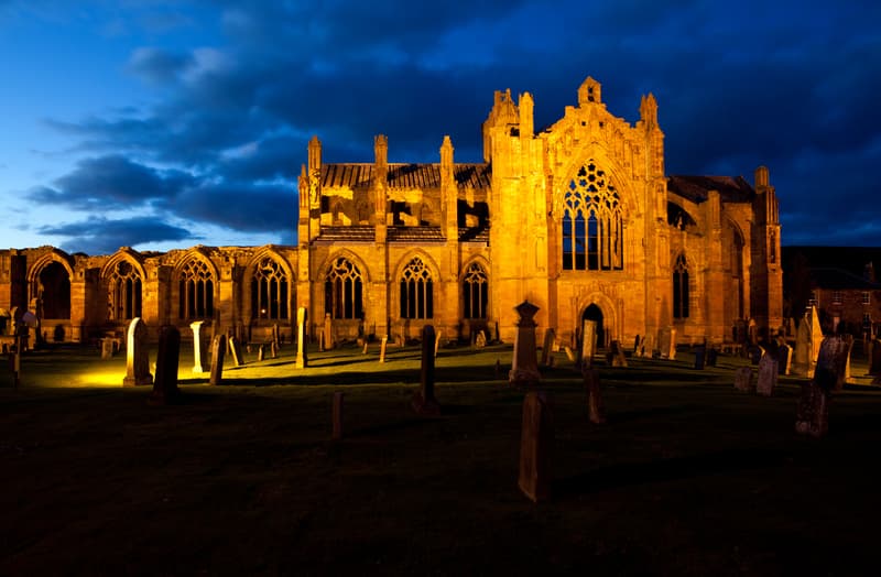 View of the abbey church from south at dusk. Ruins of Melrose Abbey, Melrose, Scotland.