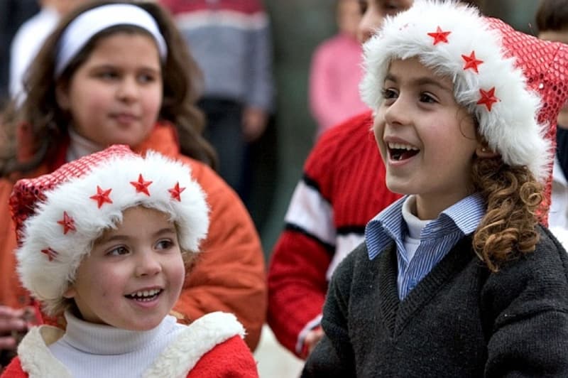 Children enjoy the Christmas play in Bethlehem.