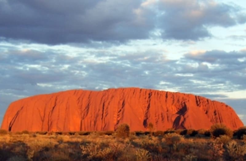 Uluru glowing spectacularly at sunset.