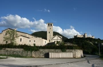 View from outside the monastery walls, with the medieval Rocca crowning the hill in the distance.