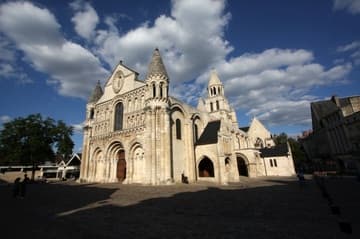 View of Notre-Dame-la-Grande from the southwest. Famed for its magnificent west facade, the Romanesque collegiate church was built between the late 11th century and the middle of the 12th century.