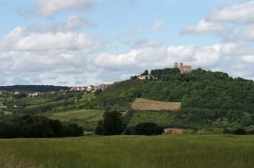 A scenic view of the Basilique Ste-Madeleine from the east and the town of Vezelay stretching along the hill below it.