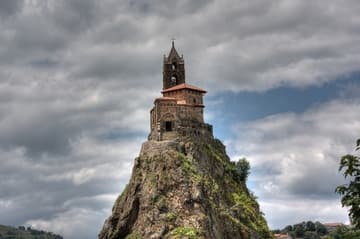 View of Saint Michael's Chapel from the southeast. The large square section with the pyramidal roof is the original 10th-century sanctuary; the portal and tower were added in the 12th century.