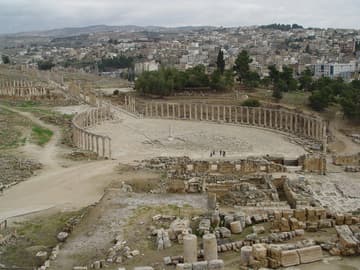 View of the Oval Plaza, Temple of Zeus (foreground), and new city of Jerash from the theater.