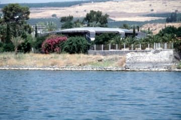 View of Capernaum from the Sea of the Galilee. The large building is a modern (1990) Franciscan church that stands over the ruins of the House of St. Peter.