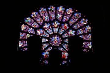 The west rose window at Notre Dame dates from about 1220. Unfortunately, the interior view of its colorful medieval glass is now more than half blocked by the great organ. The main theme of the west rose is human life, featuring symbolic scenes such as the zodiac signs and Labors of the Months.
