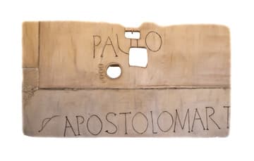 Replica of the marble slab placed over the tomb of Saint Paul in the Constantinian period (early 4th century). It measures 2.12 x 1.27 m and was about 4.5 m above St. Paul's sarcophagus. A new censer was placed through the round hole on the festival day of the saint each year. The rectangular openings, cut later than the round one, were used to introduce objects into the saint's tomb, which pilgrims could then bring home for veneration. Displayed in San Paolo fuori le Mura (St. Paul Outside the Walls), Rome, Italy.
