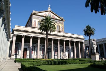 View of the basilica from the quadriportico with statue of St. Paul, looking east. San Paolo fuori le Mura (St. Paul Outside the Walls), Rome, Italy.