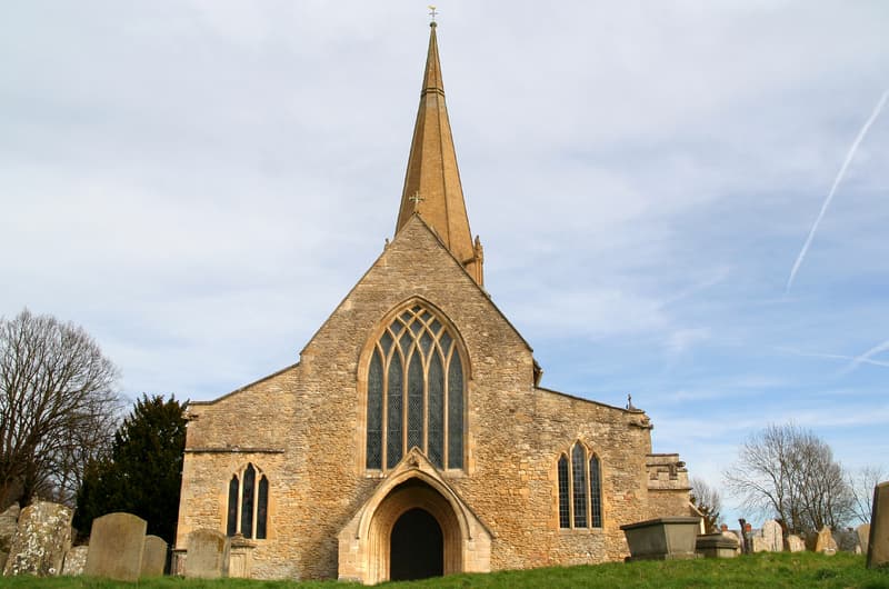 Exterior view from west, 12th-13th century. Bampton Church, Oxfordshire, England.